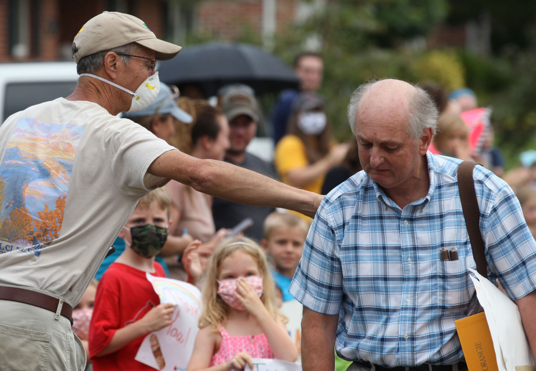 A resident pats Rudloff on the back